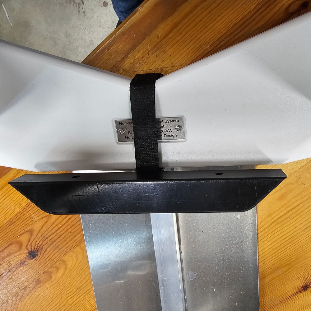 NorDav swivel plate elevator mount block secured flat against a teak marine swim platform deck in Oceania.