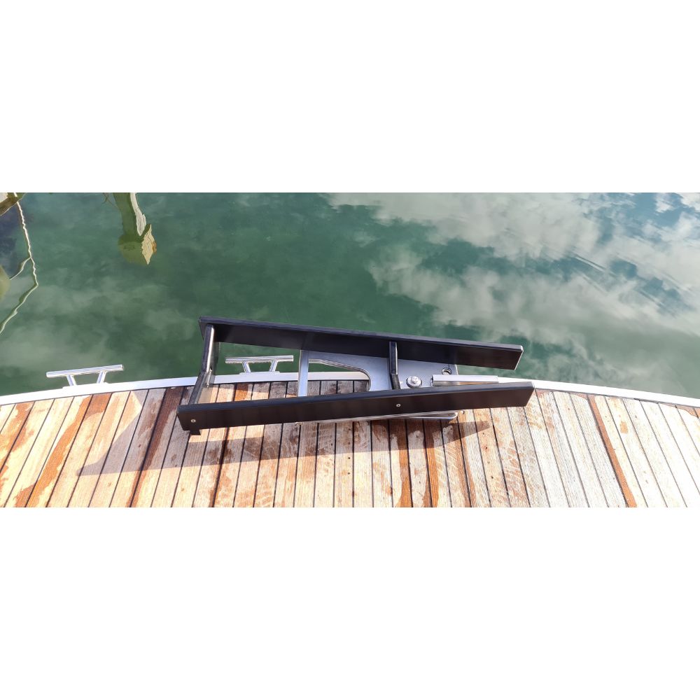 Overhead view of the unboxed black NorDav V-Series 350kg vertical davit kit contents, showing hardware bolts, straps, and winch assemblies.