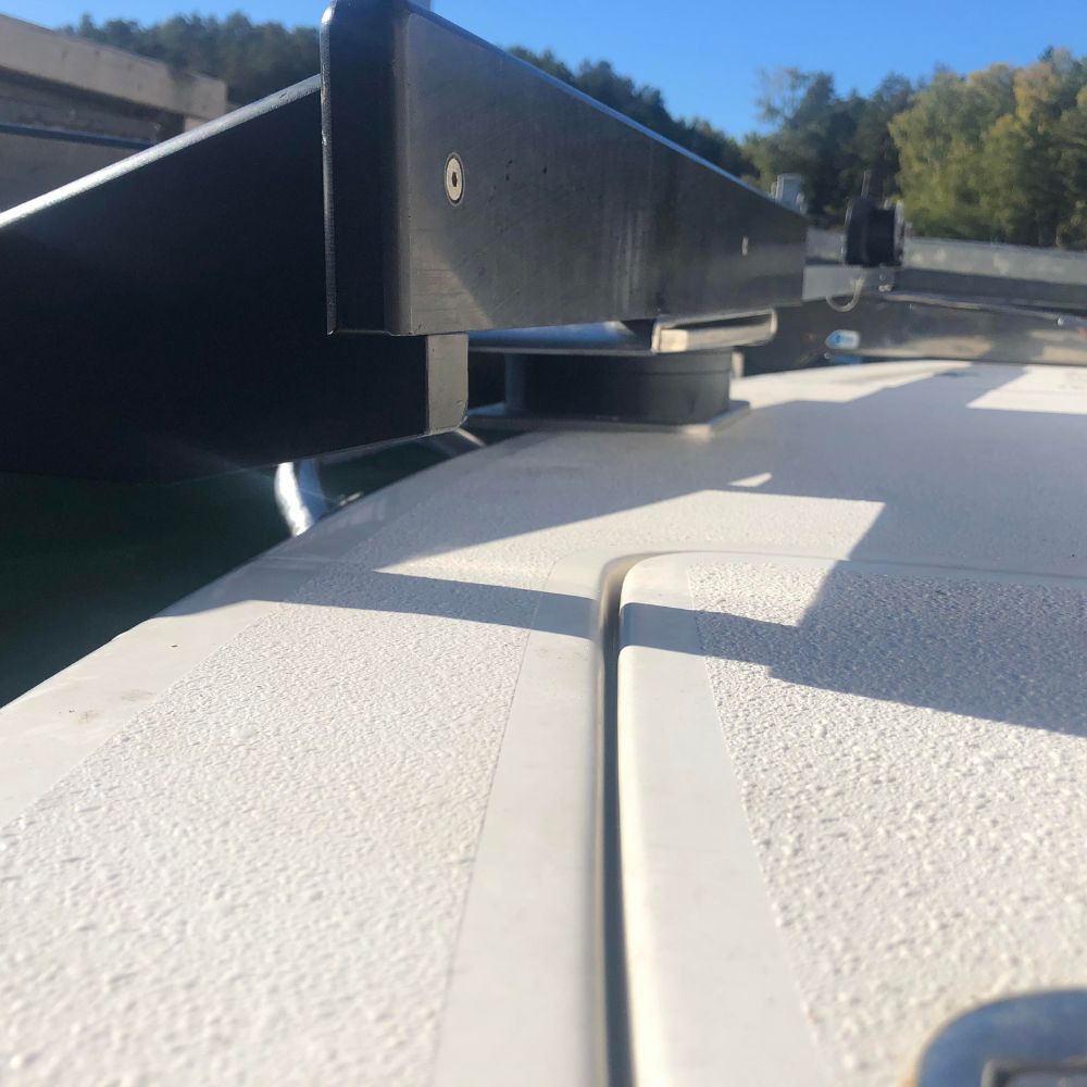 Adjustable swivel plate davit riser block allowing for custom vertical alignment steps on a yacht platform.