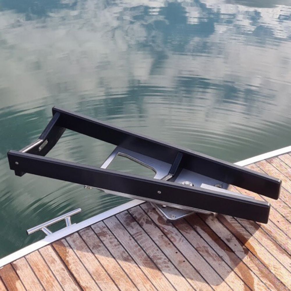 Heavy-duty black NorDav V-Series space-saving vertical profile swivel yacht davit system mounted securely to a transom swim step.