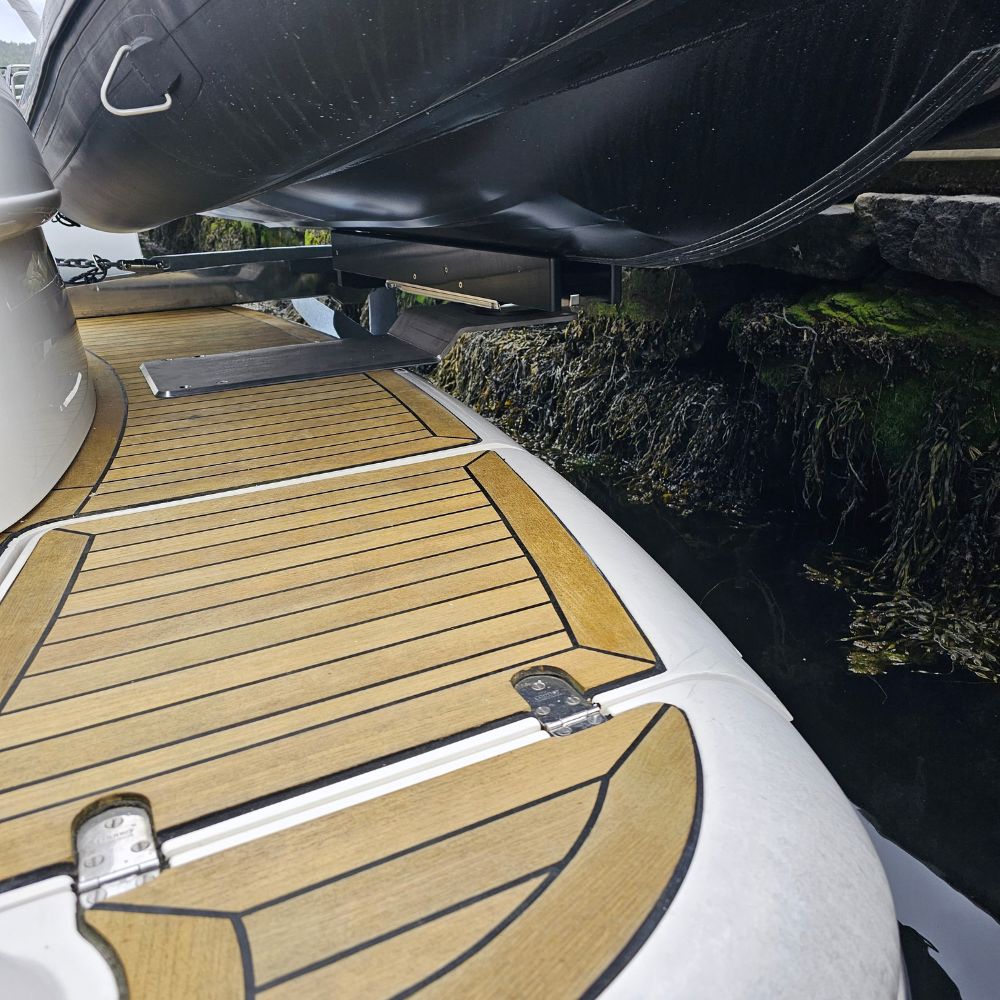 Extended luxury yacht tender hoist system utilizing the NorDav XXXL extended structural riser plate to lift a large diesel rigid inflatable boat.