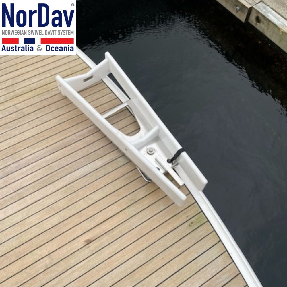 Close-up view of the space-saving transom mount deck bracket installation for a white NorDav V-type vertical davit system.